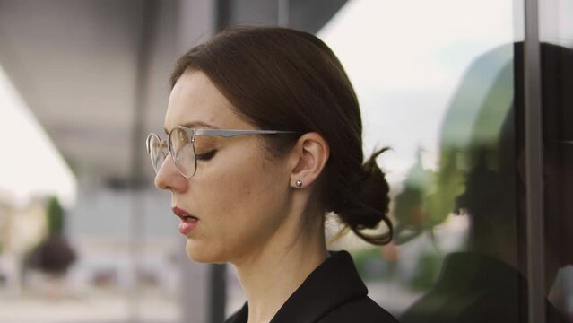 Upset young woman staying outdoor, deeply breathing trying to calm down, suffering sexual harassment at work, macro face close-up