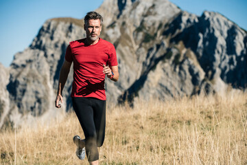Austria, Tyrol, man running in the mountains