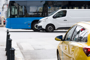 Taxi, van and bus on a street