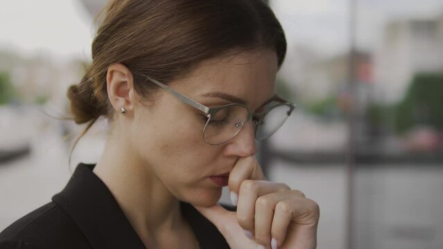Anxious thoughtful woman preparing to speak in front of large audience, nervous and embarrassed, parliamentary candidate preparing to give persuasive speech, macro close-up
