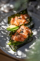 Portion of appetizing trendy sushi hand rolls with salmon