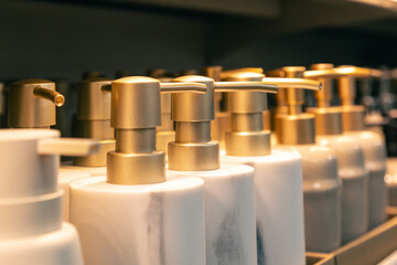 Containers for liquid soap or shampoo with a dispenser is sold in a supermarket.