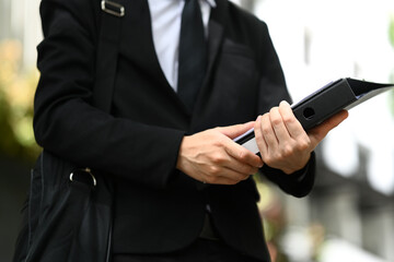 Businessman with briefcase walking on the city street, going to work