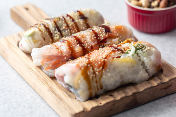 Group of spring rolls with rice paper filled with vegetables.