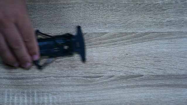 Black chasis pushed to the right on a table for a test, Tamiya Mini 4X4