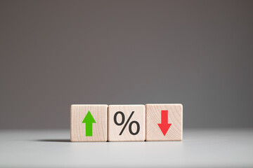 Percentage icon and up and down arrow icon  on wooden block. Changes in interest rate. Financial...