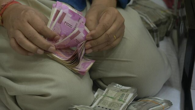 Hand counting 2000 rupee Indian banknotes, Indian currency in hand, Hand Money concept