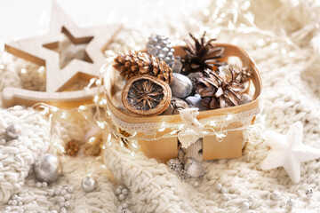 Cozy winter still life, Christmas decorations on cozy blanket.