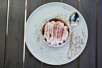 Yummy Banoffee pie beautifully plated with chocolate sauce. Decorated with whipped cream, Nutella balls and a few chocolates on side