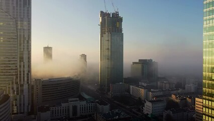 Smog or fog with toxic gases over modern city, Warsaw, Poland during a cold morning in early winter.