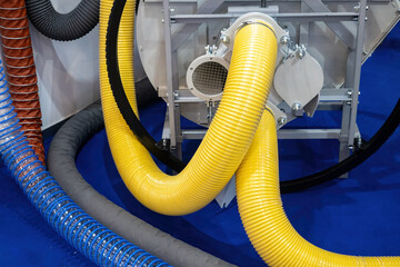 Hoses are connected to production equipment. Multi-colored flexible pipes are connected to machine....