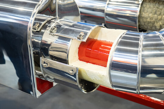Pipe is protected by polyurethane foam and steel casing. Pipeline fragment. Galvanized body on thin pipe. Sectional fragment of pipeline. Production equipment. Pipe production concept