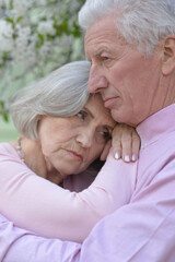 Portrait of sad senior couple in the park