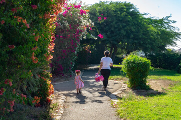 parent and child walking in park