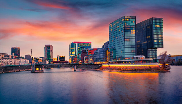 Incredible autumn sunset on the Rhein river. Spectacular evening cityscape of Dusseldorf with Medienhafen, Nordrhein-Westfalen, Germany, Europe. Traveling concept background..