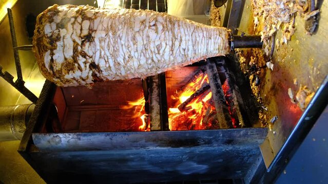 Grilled chicken meat on a vertical rotisserie used in traditional turkish street food Doner Kebab, Shawarma or Gyros in other cultures, in Istanbul, Turkey 