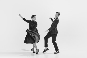 Rhythmic. Black and white. Stylish, elegant young couple, man and woman in stylus clothes dancing....