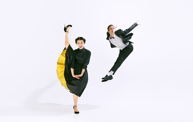 Funny emotions. Stylish, artistic young man and woman dancing lindy hop isolated on white studio...