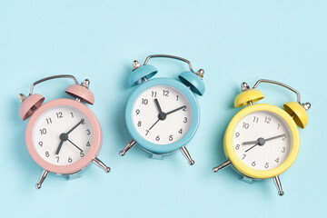 Collection of alarm clocks of different colors show different times. Start of the day, waking up,...