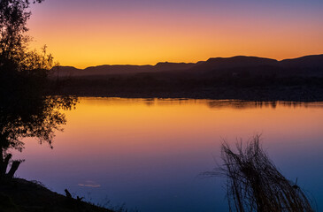 Sunset over the Orange river, on the border between Namibia and South Africa.