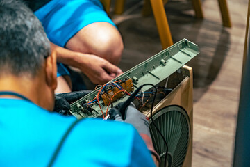 Electrician repairing a broken fan close up