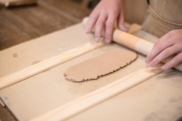 girl hands, pottery studio and painting cup in workshop for sculpture