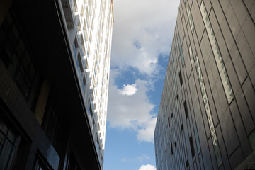 Low angle looking up at tall corporate glass building
