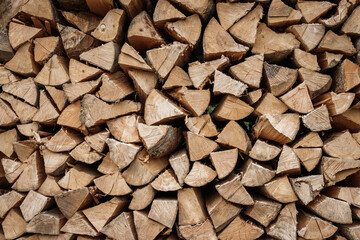 Stacked firewood background. Drying of chopped timber wood. Woodpile is ready for winter season