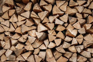 Stacked firewood background. Drying of chopped timber wood. Woodpile is ready for winter season