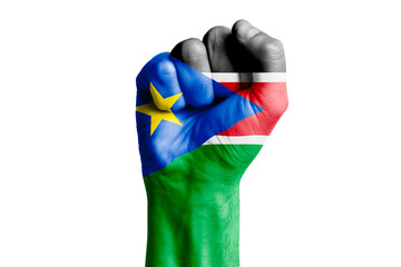 Man hand fist of SOUTH SUDAN flag painted. Close-up.