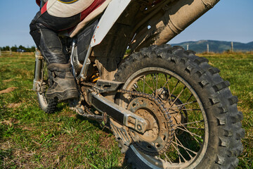 Close up photo of a professional motocross rider in action, showcasing the tire and various...
