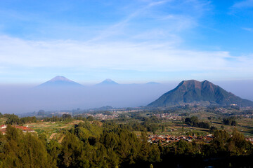 view of the peaks of several mountains at sunrise in the morning