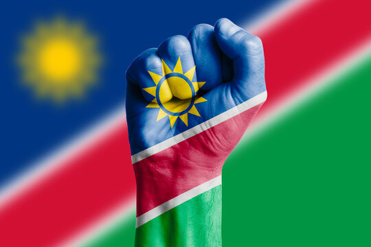 Man hand fist of NAMIBIA flag painted. Close-up.