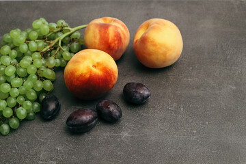 Plums, grapes, peaches. Still life with pears, grapes and plums. Healthy nutrition fruit delicious organic diet.