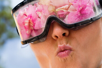 Woman wearing protective googles filled up with flowers - obrazy, fototapety, plakaty
