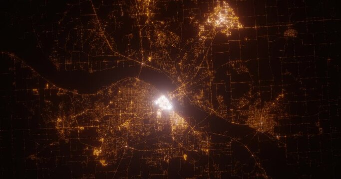 Peoria (Illinois, USA) aerial view at night. Top view on modern city with street lights. Camera is zooming out, rotating counterclockwise. Vertical video. The north is on the left side
