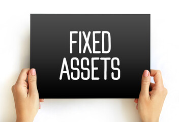 Fixed Assets - long-term tangible piece of property or equipment that a firm owns and uses in its operations to generate income, text concept on card