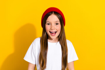 Photo portrait of adorable small girl look up empty space shopping dressed stylish white outfit isolated on yellow color background