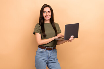 Photo of smart charming girl dressed khaki t-shirt chatting instagram twitter telegram facebook isolated beige color background