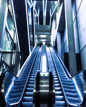 Vertical shot of an escalator inside the Gare de Champel train station in Geneva