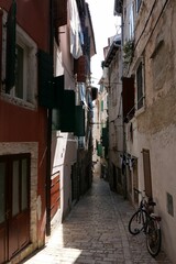 Fototapeta na wymiar Vertical shot of a narrow street with buildings