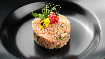 Cous-cous on a black plate