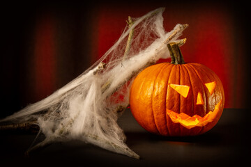 Halloween pumpkin with candles on dark background, shallow depth of field