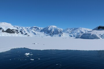 a body of water filled with melting ice in the snow