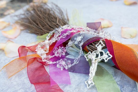 a cross is tied to a bunch of ribbons and ribbon