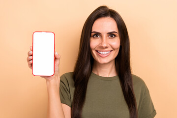 Photo of charming cute girl dressed khaki t-shirt rising apple samsung iphone device empty space...