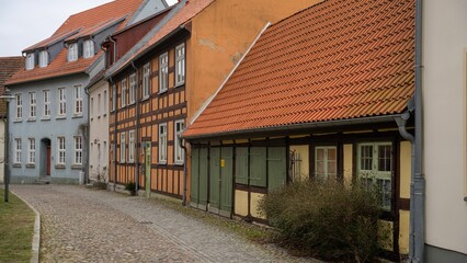 two buildings on a cobble stone street in the city