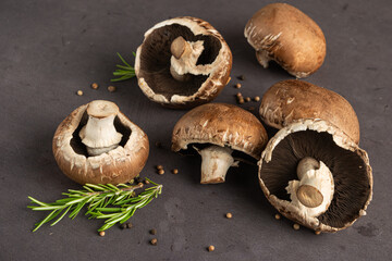 Close-up of mushroom on a cutting board. Cooking mushrooms on the kitchen table with spices and rosemary