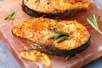 Salmon steaks cooked on a salt slab