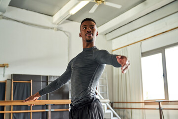 boy black dancer in a warm-up and dancing in a ballet class